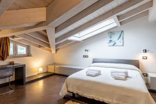 a bedroom with a large bed with two towels on it at Relax in Villa - Versilia in Massa
