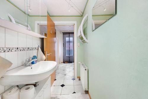 a bathroom with a sink and a mirror at Landferien Schütt in Neuenkirchen