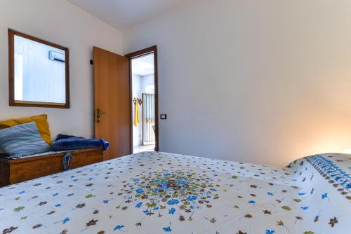 a bedroom with a bed and a mirror and a window at Casa Vacanze Iosè in Rio Marina