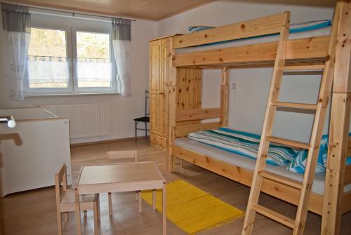 a room with two bunk beds and a table at Ferienhof Siber in Owingen