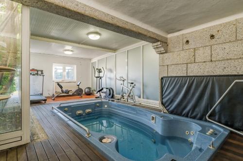 a large blue tub in a room with a gym at W430 Guimarães in Guimarães