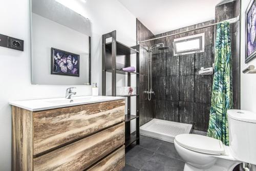 a bathroom with a sink and a toilet and a shower at Bright in Agaete