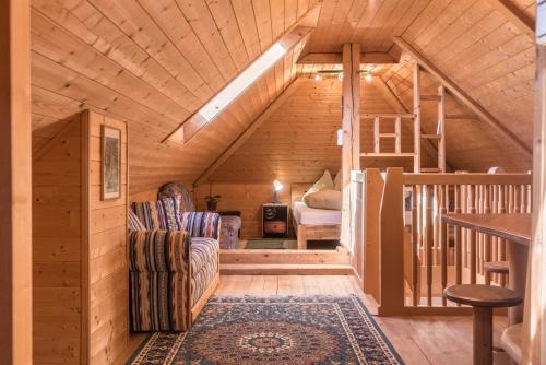 a log cabin with a staircase and a living room at Apartment Vigl Lodge in Collalbo