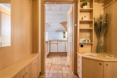 a kitchen with a hallway with a table and a counter at Apartment Vigl Lodge in Collalbo