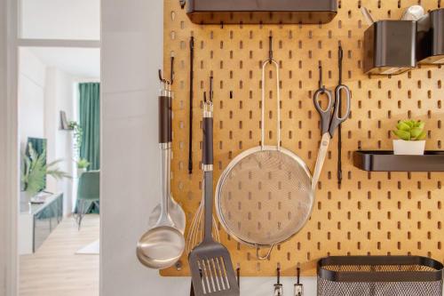 a kitchen with utensils hanging on a wall at Global Bnb - Loft 28 Green in Augsburg