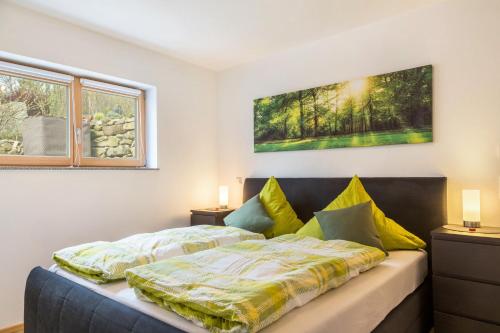 a bedroom with a bed and a window at Bauzinger Alm in Hauzenberg