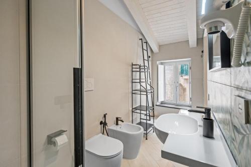 a bathroom with a toilet and a sink and a mirror at Residenza Borgo Antico Lucia in Ascea