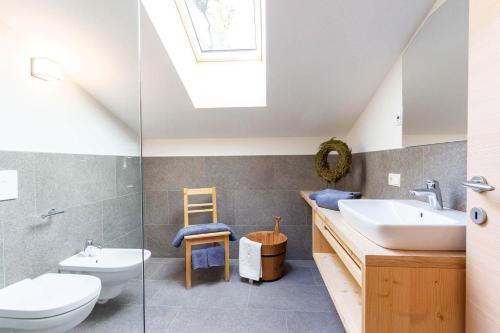 a bathroom with a sink and a toilet at Daimlhof Ferienwohnung Moosherz in Völs am Schlern