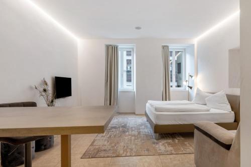 a living room with a bed and a couch at App 103 Palazzo Cavour in Bolzano