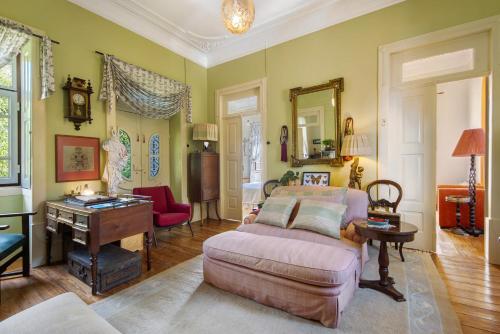 a living room with a couch and a table at Guest House Casa S Martinho in Oliveira de Azemeis