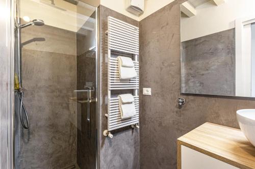 a bathroom with a shower with a glass door at Nido di Cisano in San Felice del Benaco