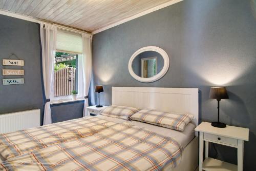a bedroom with a bed and a mirror on the wall at Ferienhaus Piet in Berumbur
