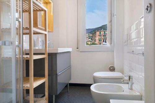 a bathroom with a toilet and a sink and a window at Il Mughetto in Rapallo