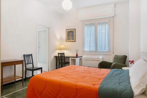 a bedroom with a bed and a desk and chairs at Il Mughetto in Rapallo