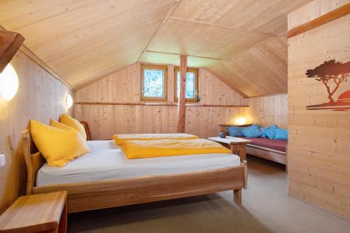 a bedroom with a bed in a wooden cabin at Ferienhaus am Ried in Ostrach