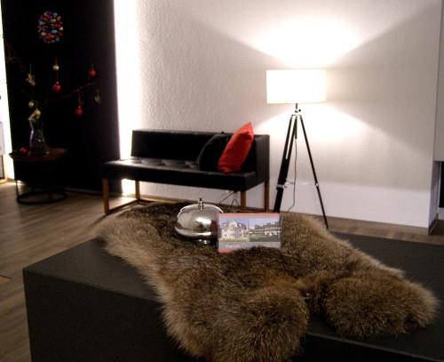a brown teddy bear laying on top of a white couch at Haus Katharina Hotel garni in Bad Steben