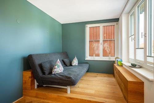 a living room with a chair and a window at Ferienwohnung Lauterach in Lauterach