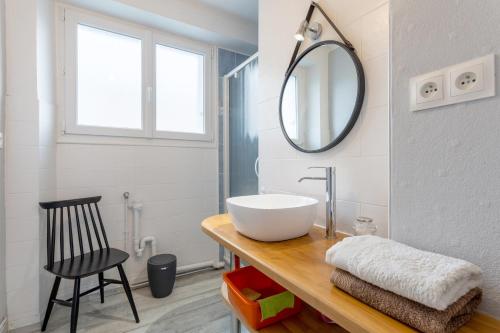 a bathroom with a sink and a mirror on a counter at Appartement face Mer - 50m plage in Douarnenez