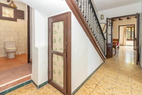 a hallway of a house with a toilet and stairs at Masía Can Garriga, Casa Gran in Girona