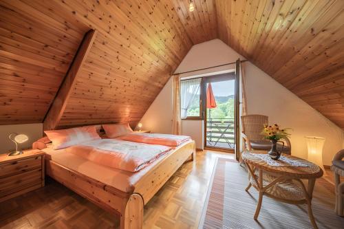 a bedroom with a large bed in a wooden ceiling at Kornbauernhof in Oberharmersbach