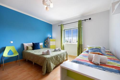 a bedroom with two beds and a window at Villa Delphin in Lagos