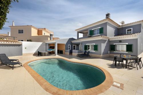 a villa with a swimming pool in front of a house at Villa Delphin in Lagos