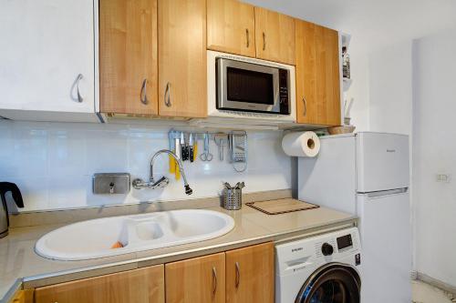 a kitchen with a sink and a microwave at Los Molinos 538 in Maspalomas