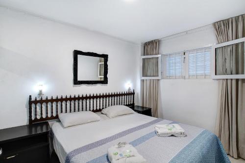 a bedroom with a bed with two towels on it at Los Molinos 538 in Maspalomas