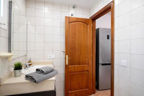 a small kitchen with a sink and a refrigerator at Casa Sabrina, Terraza Vista Mar in Playa Honda