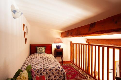 a small bedroom with a bed and a balcony at Les Cigales in Ceyreste