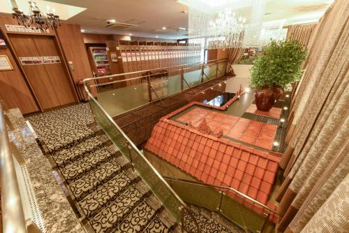 an overhead view of a store lobby with escalators at Anshin Oyado woman Tokyo Ginza Shiodome in Tokyo