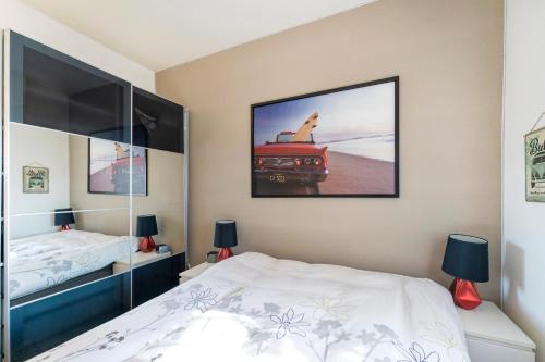 a bedroom with a bed and a picture of a truck at Maison Cosy, Lac et Plages in Hossegor