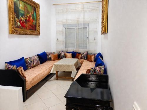 a living room with a couch and a table at Spacious 2BR Apartment with Moroccan Salon near Aquaparc Tamaris Casablanca in Casablanca