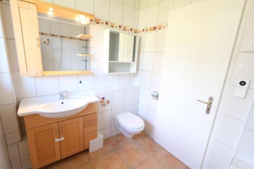 a bathroom with a sink and a toilet at Apartment Bünda in Davos
