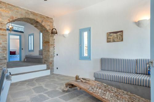 a living room with a staircase and a couch at Sylvia's Home in Sifnos