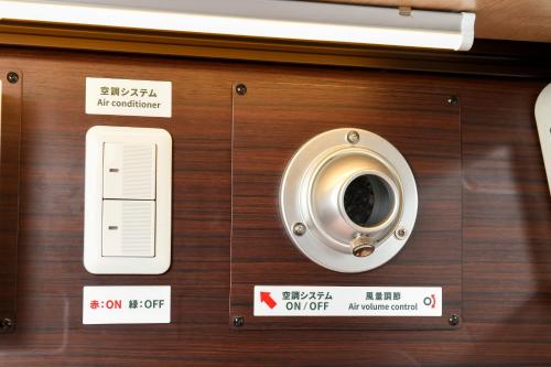 a wooden door with signs on it at Anshin Oyado woman Tokyo Ginza Shiodome in Tokyo