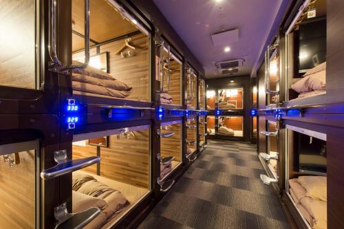 a corridor of a train with bunk beds at Anshin Oyado woman Tokyo Ginza Shiodome in Tokyo