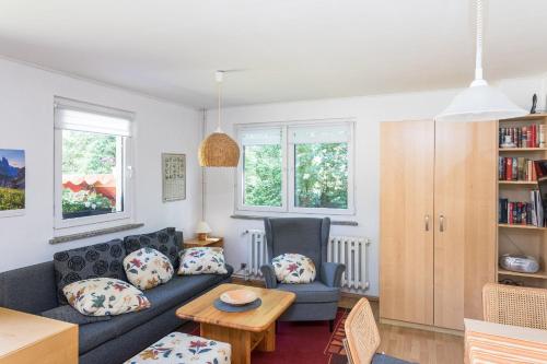 a living room with a couch and a table at Ferienhaus Krohse in Potsdam