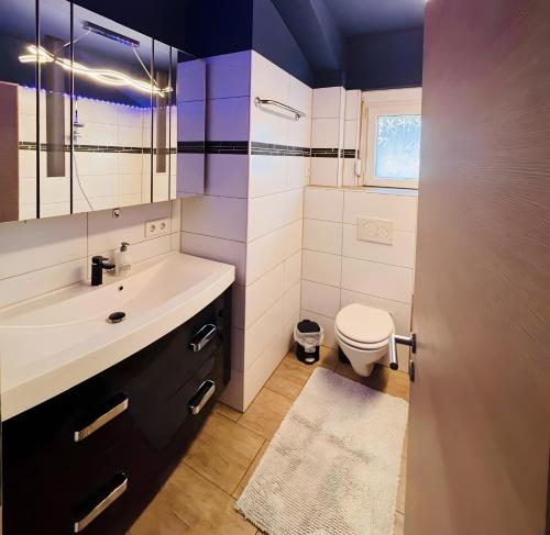 a bathroom with a sink and a toilet at Ferienwohnungen in Lohr in Lohr am Main