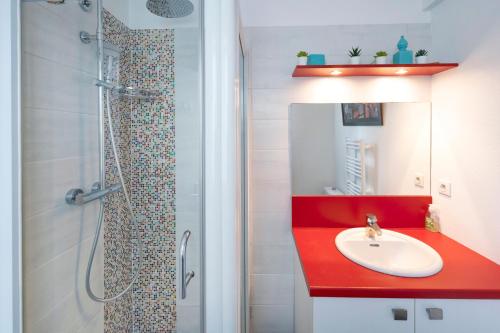 a bathroom with a red sink and a shower at Entre Terre et Mer in Ciboure