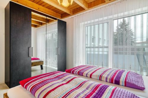a bedroom with a bed and a large window at Ferienwohnungen Böhme in Konstanz