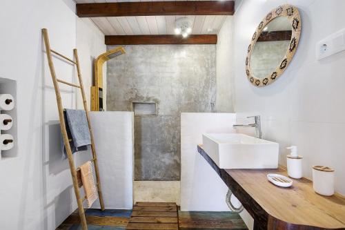 a bathroom with a sink and a mirror at Ca Lajares in Lajares