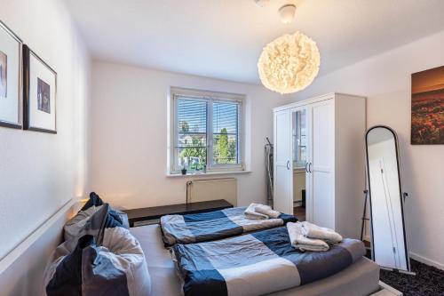 a bedroom with two beds and a mirror at Ferienwohnungen Neuseenland in Rötha