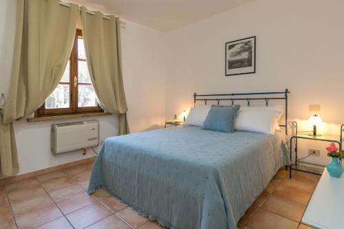 a bedroom with a bed and a window at Podere Nuti - 3 Vallino in Cecina