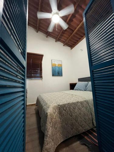 a bedroom with a bed and a ceiling fan at MountainzenEscape in Los Altos de Cerro Azul
