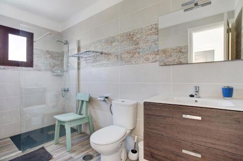 a bathroom with a toilet and a sink and a mirror at Puerto Chico 1 in Playa Blanca