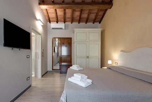a bedroom with a bed and a flat screen tv at Il Borghetto Bed and Breakfast in Borgo San Lorenzo
