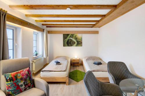 a room with two beds and a table and chairs at Vogelsberger Bett 7 die 1 in Alsfeld