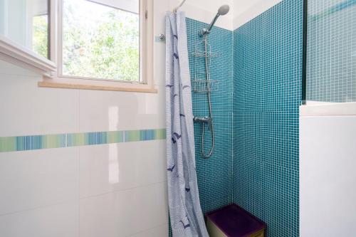 a bathroom with a shower with blue tiles at Villa Massa depandance in Polignano a Mare