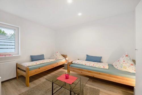 a room with two wooden beds and a window at Fewo Weber in Sankt Ingbert